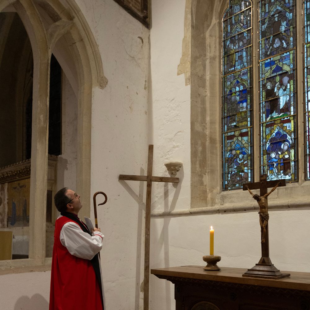 Bishop Gavin looks at the medieval window at All Saints North Moreton