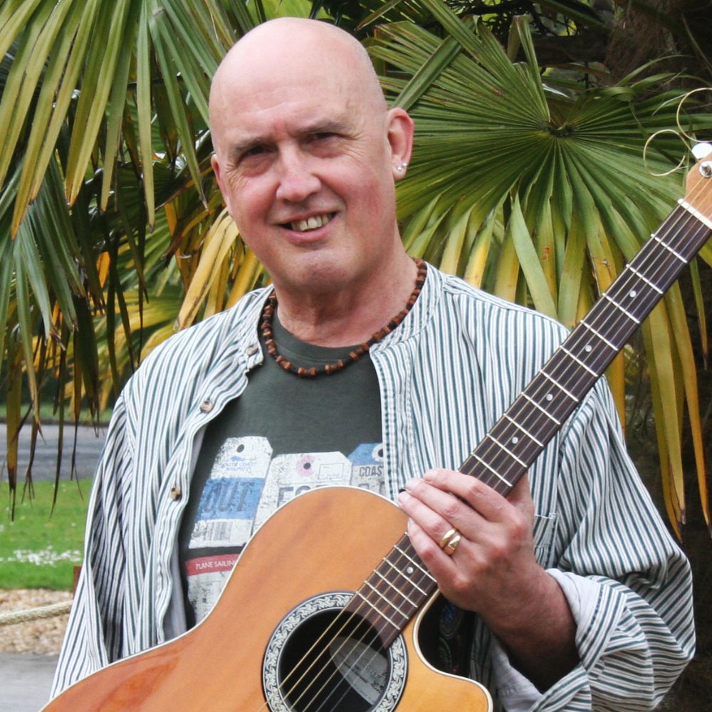 The Revd Steve Flashman holding his guitar.