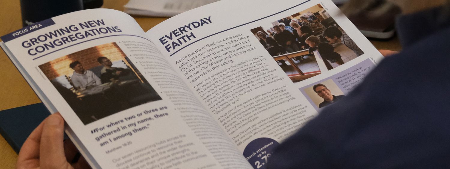 Over the shoulder photo of someone reading the Diocese of Oxford annual revoew 202