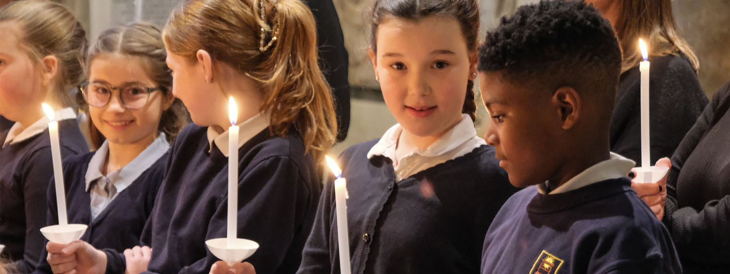 School children hold candles at e special Education church service