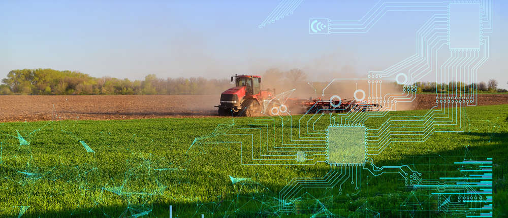 Tractor ploughing field with digital graphs and charts overlaid
