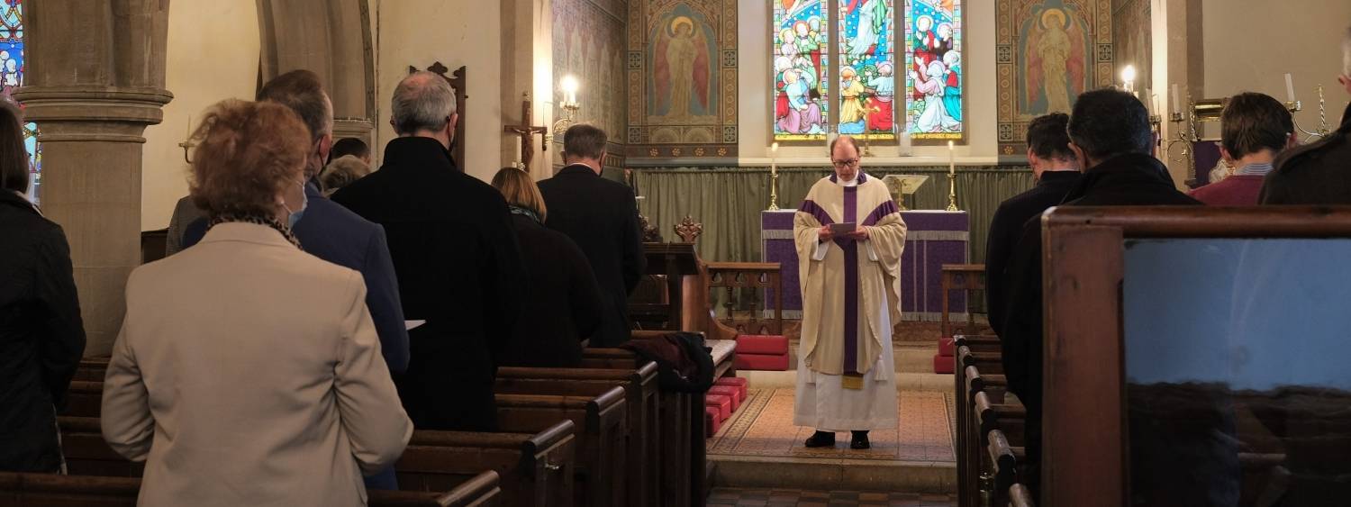 Clergy reading to a standing congregation from the Bible