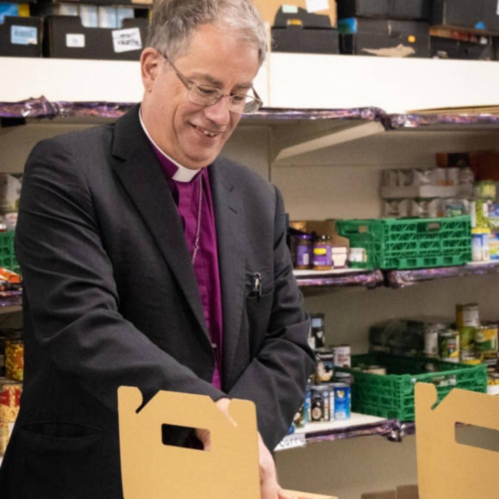 The Bishop of Oxford packing cardboard meal boxes