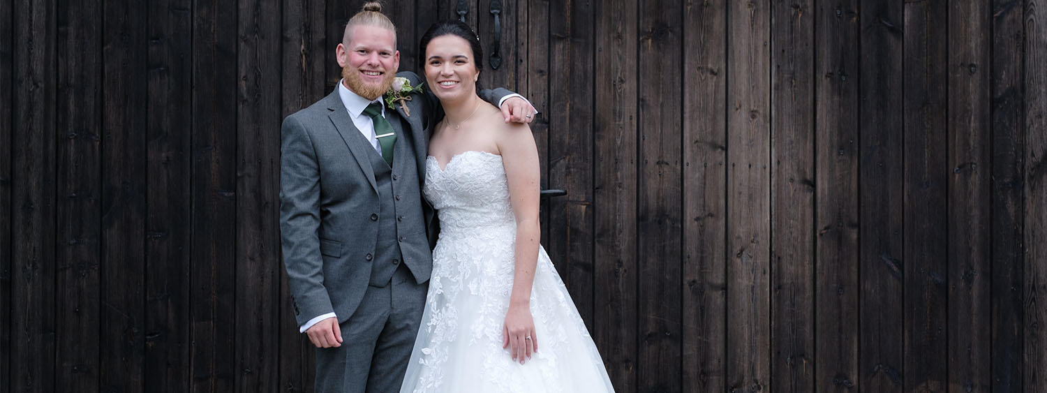 Married couple smiling happily.