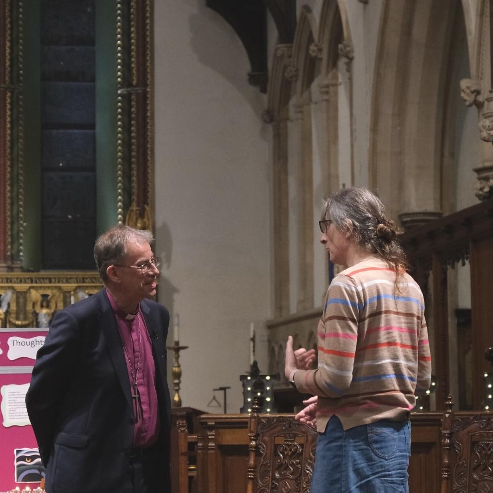 Bishop Steven is standing talking to a member of the congregation at the front of Reading Minster.