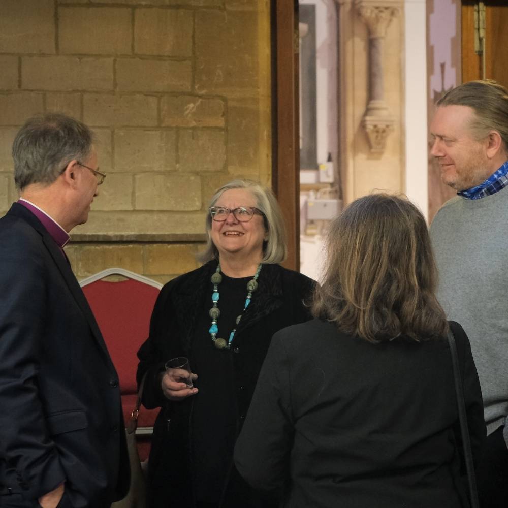 Bishop Steven standing in Easthampstead Parish Church with 3 churchwardens, all three are smiling