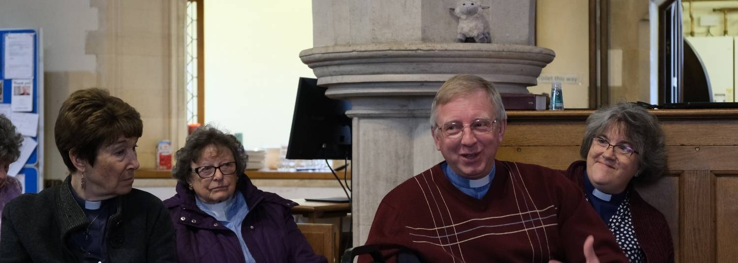 Four members of Wallingford Clergy sitting in All Saints Church Didcot, 3 are looking at Andy as he speaks to the group.