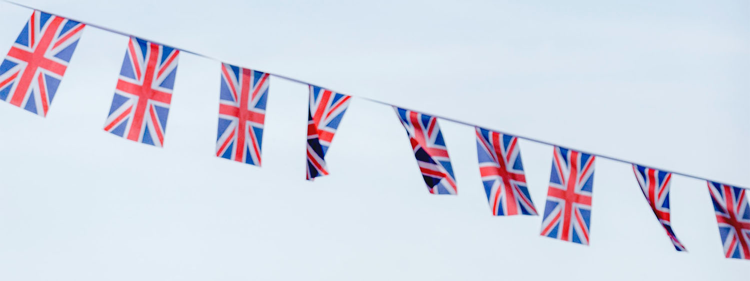Union Jack bunting against a pale blue sky