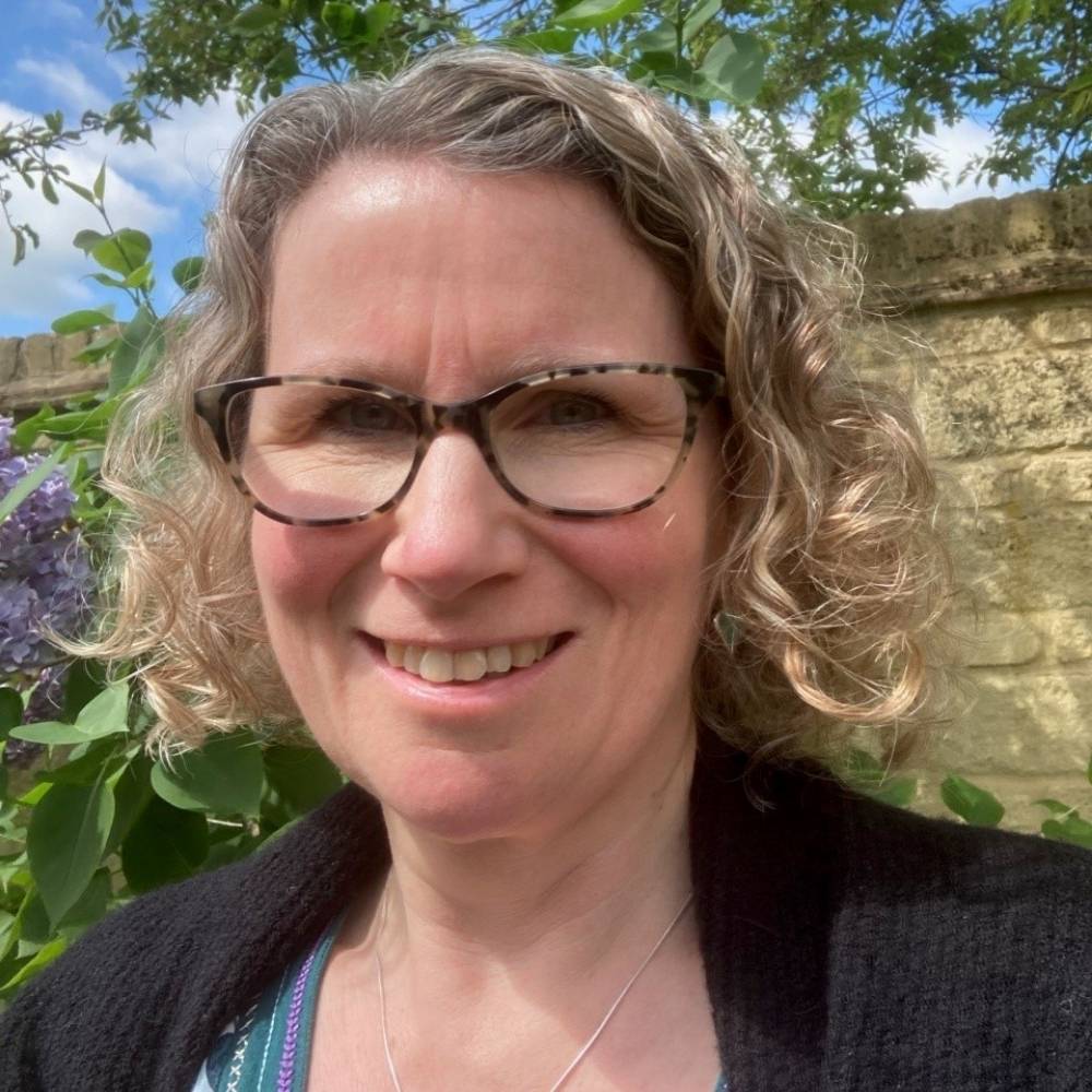 Headshot of Heather in a garden smiling