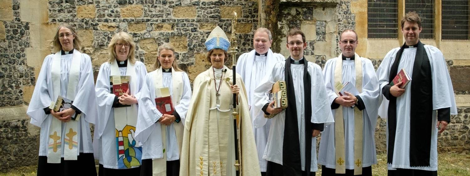 Bishop Olivia and new Reading are Priests stand smiling outside Reading Minster.