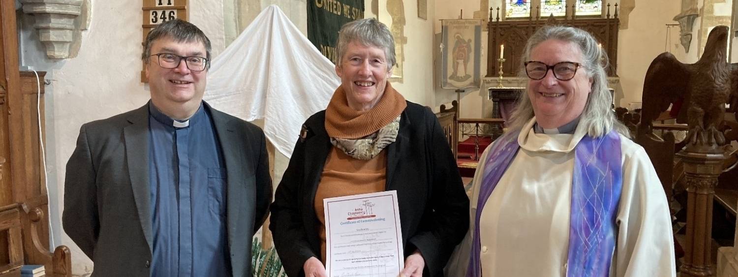 Kay standing with Archdeacon Guy and incumbent after commissioning in Buckinghamshire.