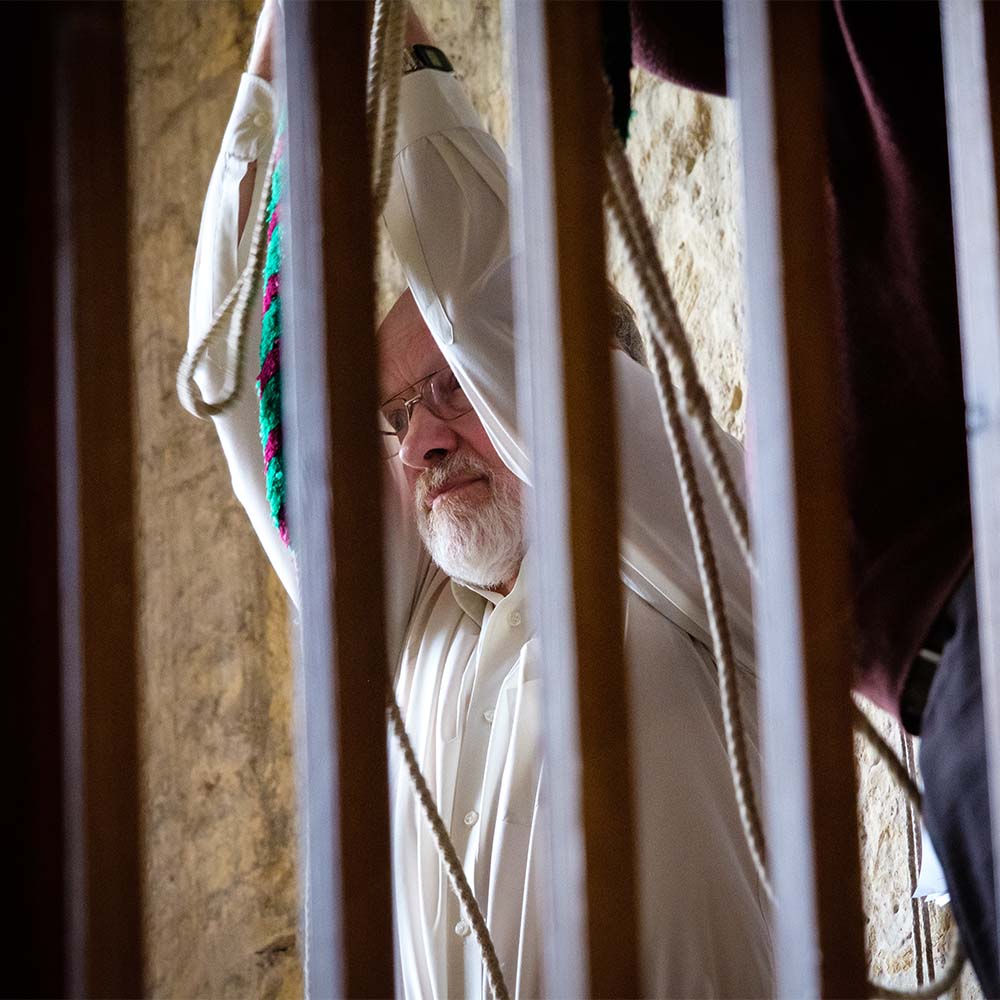 Closer shot of a man ringing church bells