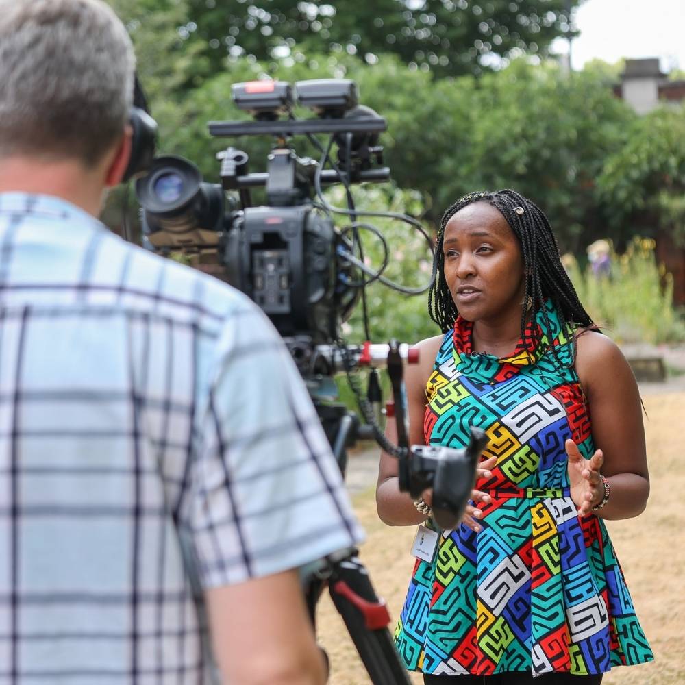 Elizabeth Wathuthi, a young climate activist from Kenya, speaks to film cameras.