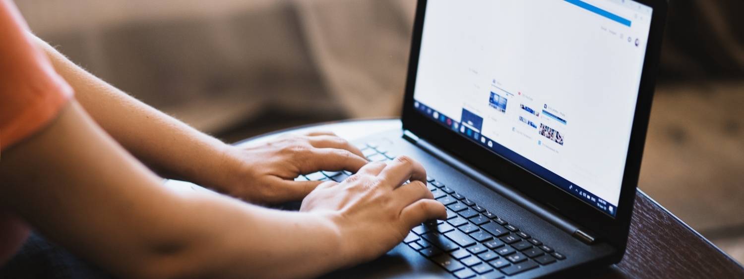 person typing on a laptop