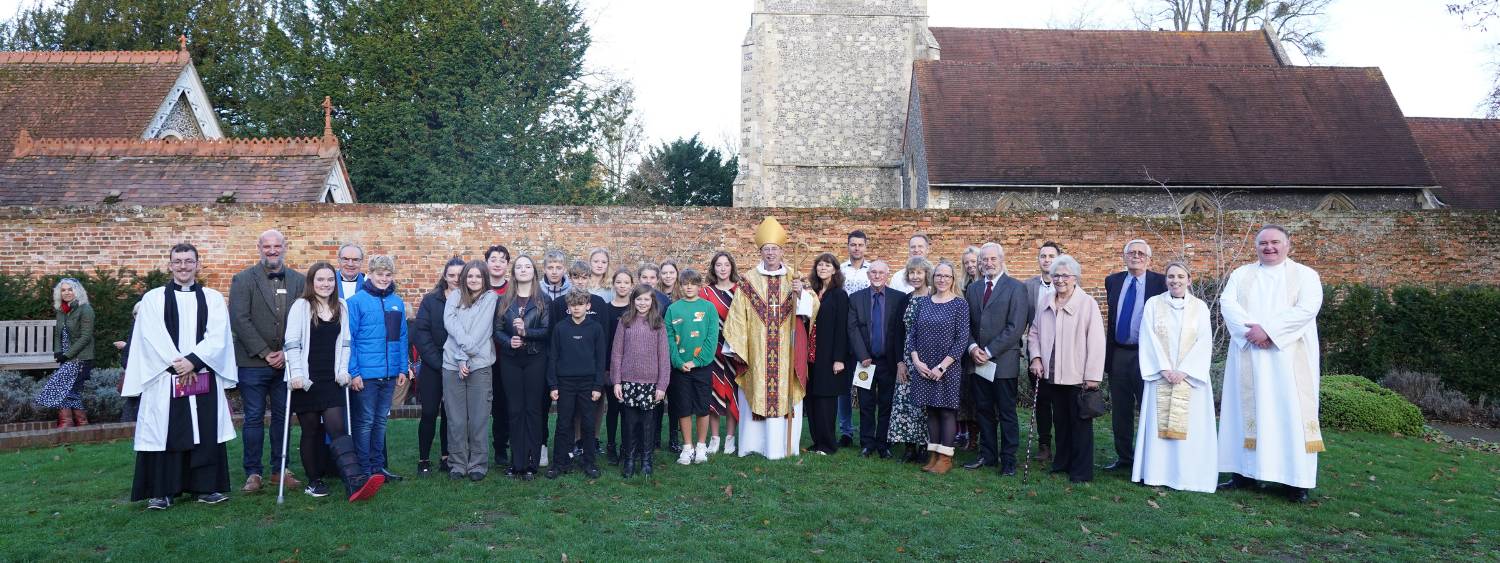 Bishop of Oxford with 28 confirmation candidates stood in the St Andrew's Churchyard in Sonning