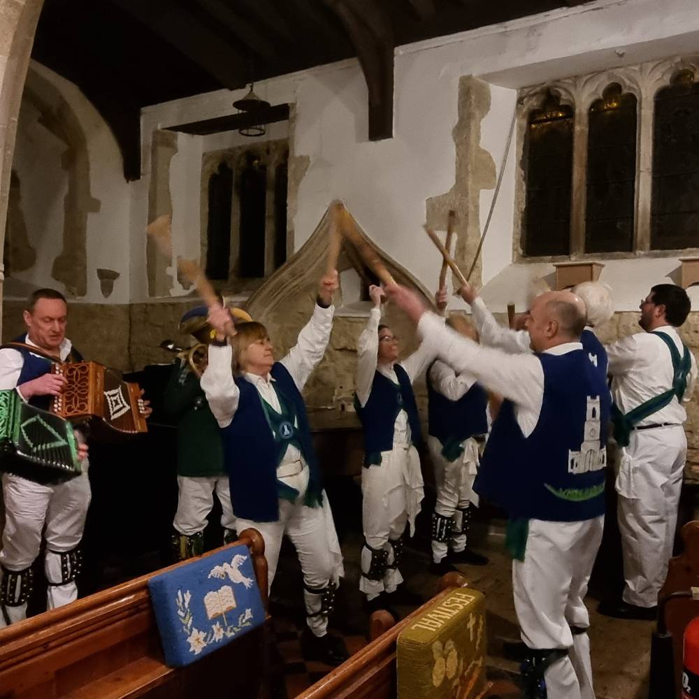 Group of Morris Dancers inside All Saints Church Oving