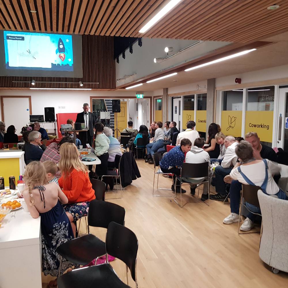 Group of adults and children meet for Hope Church bicester Quiz night on the Elmsbrook estate.