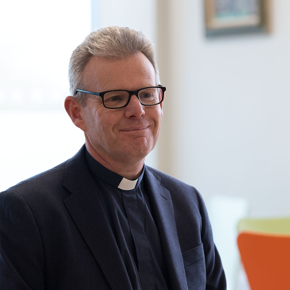 The Revd Canon David Tyler smiling and looking to the right of the camera.