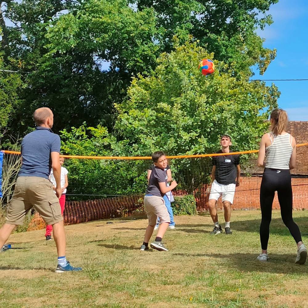 Young people playing volleyball outside 