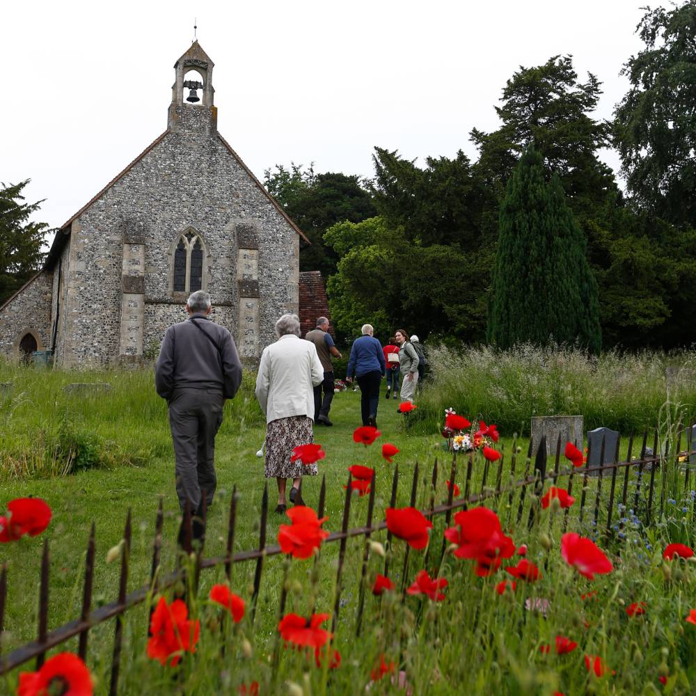 St Andrew's Churchyard with poppies and people walking