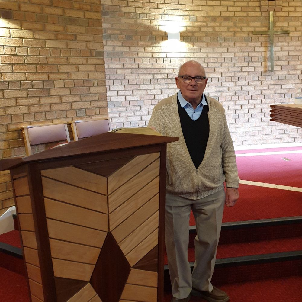 Terry stands next to a lectern in church.