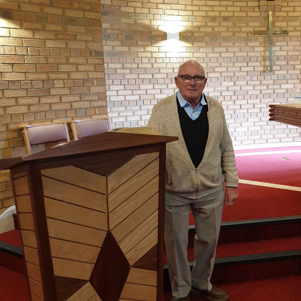 Terry stands next to a lectern in church.