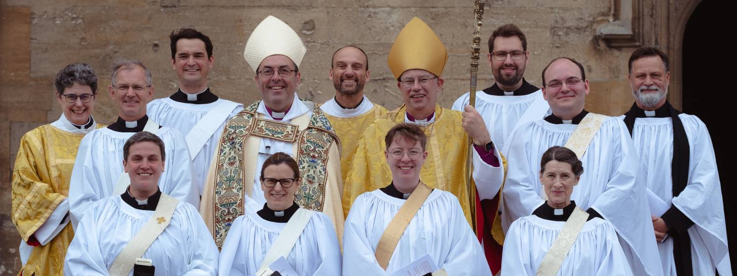 Nine new deacons stand outside Christ Church Cathedral with the Bishop of Oxford and the Bishop of Dorchester.